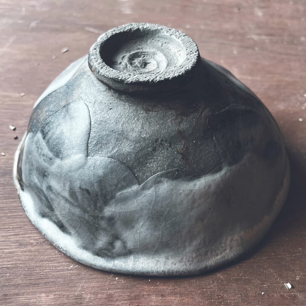 Cuenco de té en gres gris humo con esmalte degradado, visto desde el pie